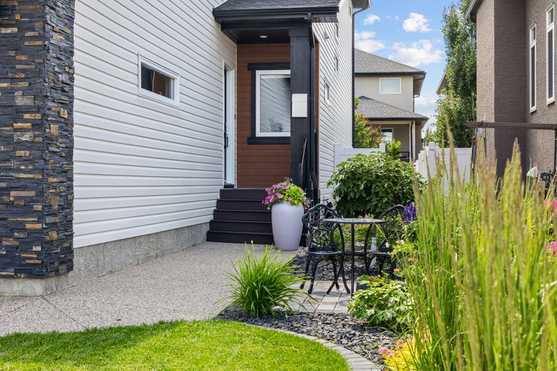 Covered front entry with a dark stained door and stone detailing