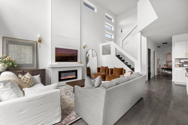Living room with sectional sofa and staircase beyond