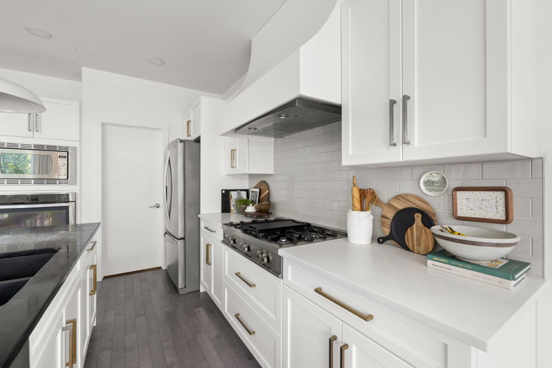 Kitchen range wall with tile backsplash and floating shelves