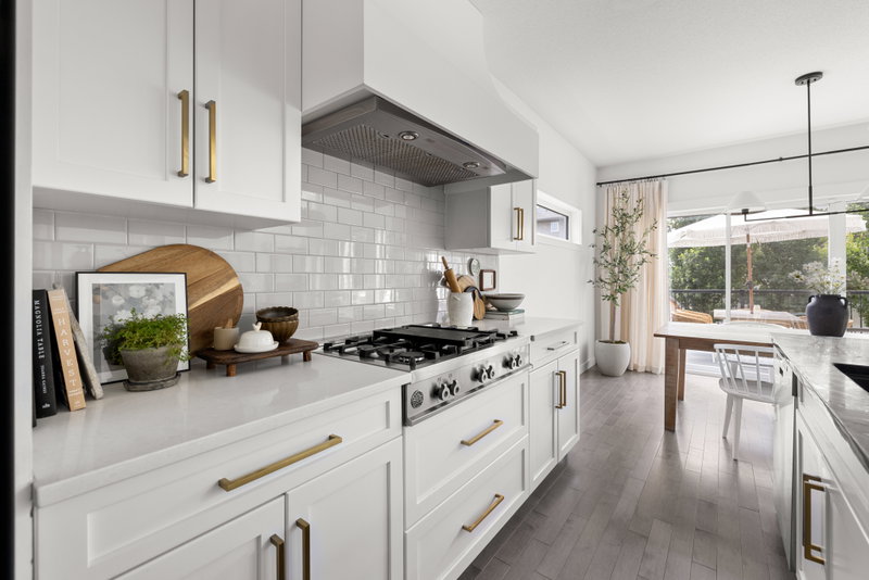 Kitchen with a view through to the dining area and windows beyond