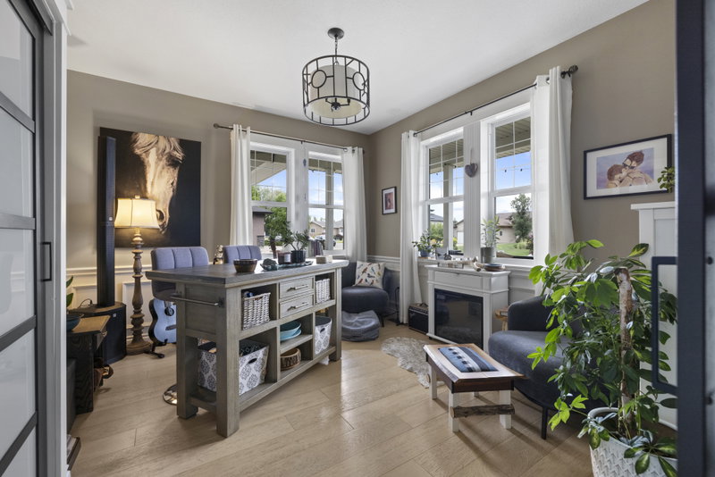 Den with built-in island desk, seating and equestrian artwork