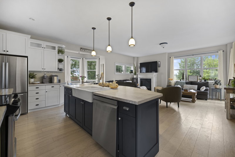 Kitchen island with farmhouse sink, open to the living room beyond