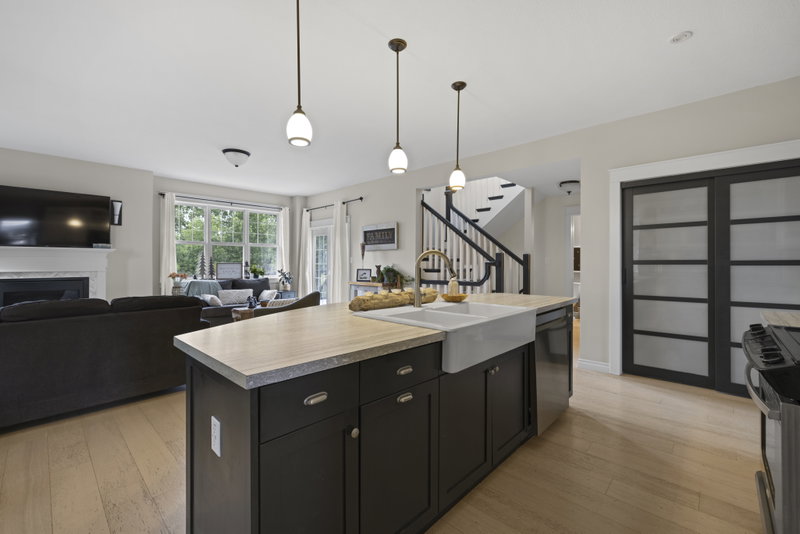 Kitchen island with a view to the staircase and mudroom