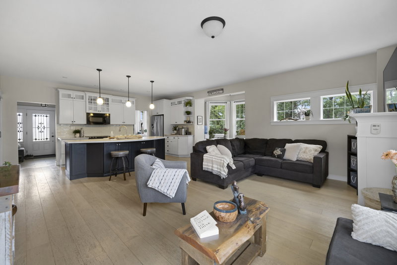 Living room open to the kitchen, with a view toward the front entry