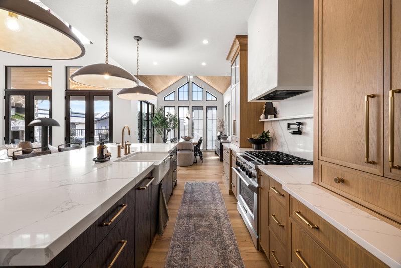 Kitchen range wall beneath a vaulted, wood-lined ceiling