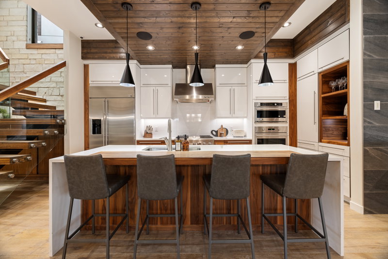 White kitchen with walnut accents and a waterfall island