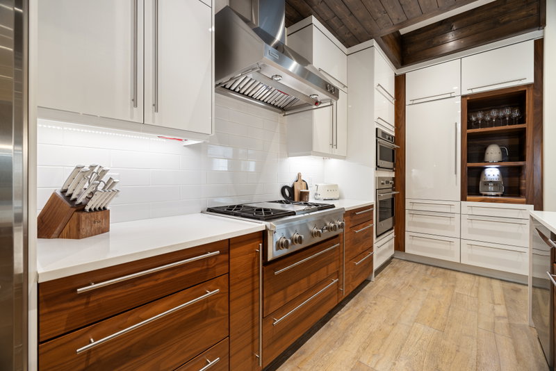 Kitchen range wall with stainless hood and subway tile