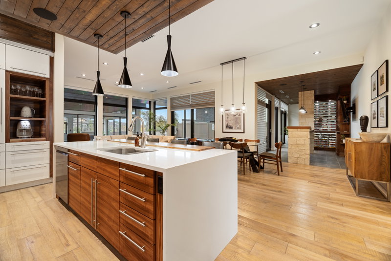 Kitchen open to the dining area and floor-to-ceiling windows
