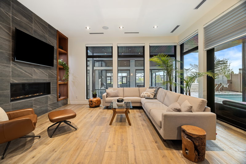Hearth room with sectional sofa and sliding doors to the pool