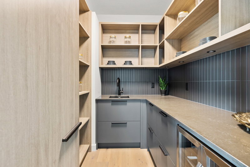 Walk-in pantry with open wood shelving