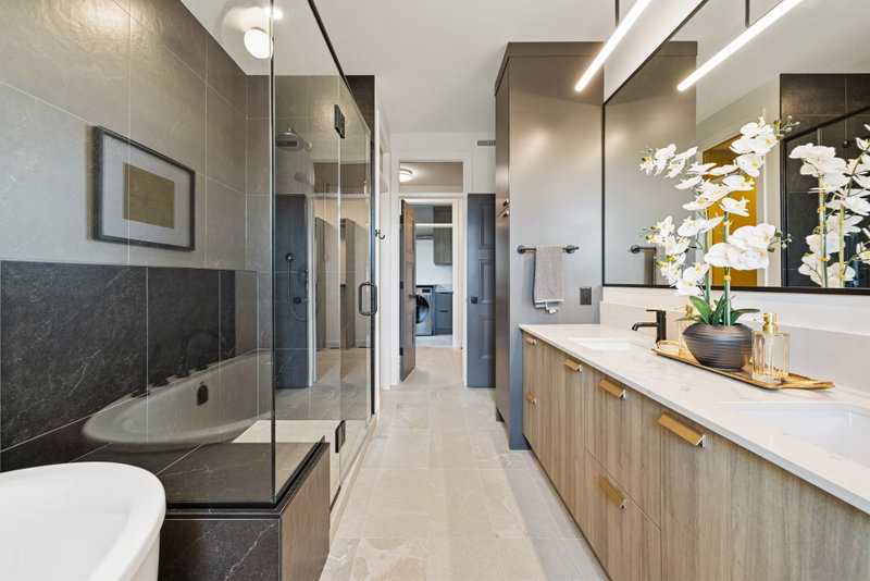 Hallway outside the primary suite with a peek into the laundry room