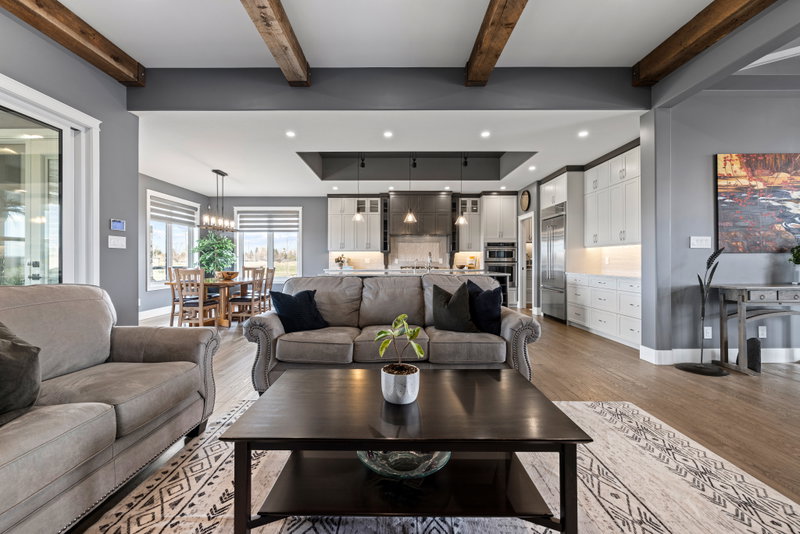 Great room with beamed ceiling, open to the kitchen and dining