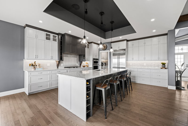 Kitchen island with granite counters and pendant lighting