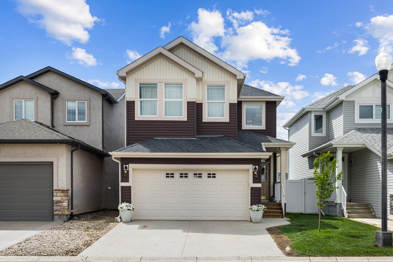Home exterior with covered entry and manicured landscaping