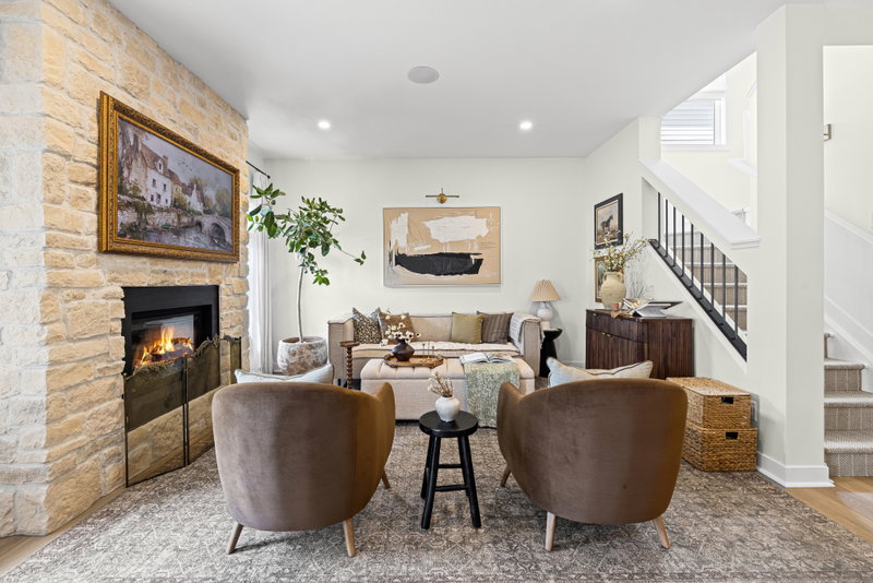 Living room with a stone fireplace and gas insert