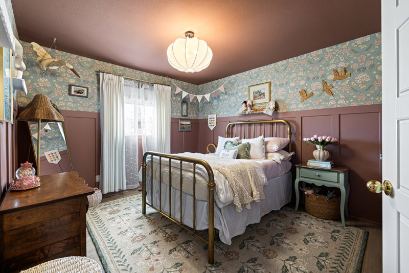 Kids' bedroom with a brass bed and bunting, second angle