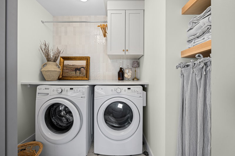 Laundry room with tiled backsplash and open shelving