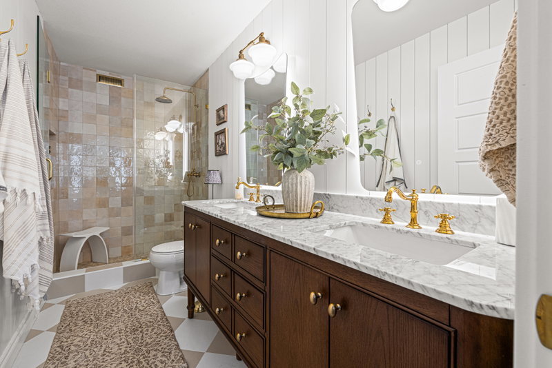 Ensuite bathroom with double vanity and brass fixtures