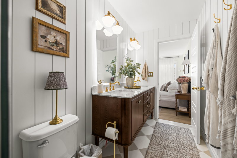 Primary ensuite with a double vanity and a view into the bedroom