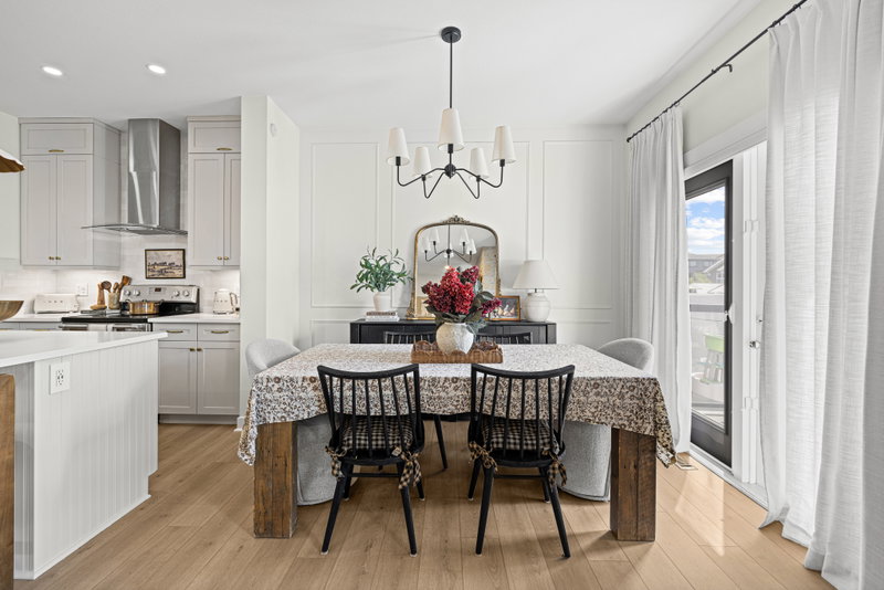 Dining room with a black spindle chandelier and framed mirror
