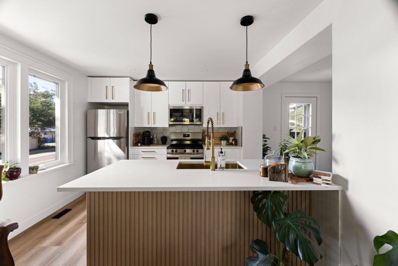Kitchen with hexagon tile backsplash and gold pendant lighting