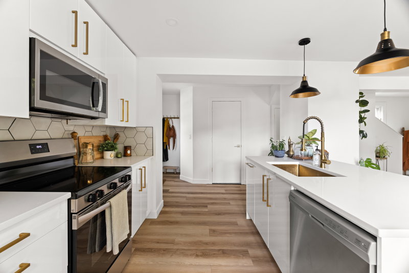 Kitchen island with brass sink, open to the living room