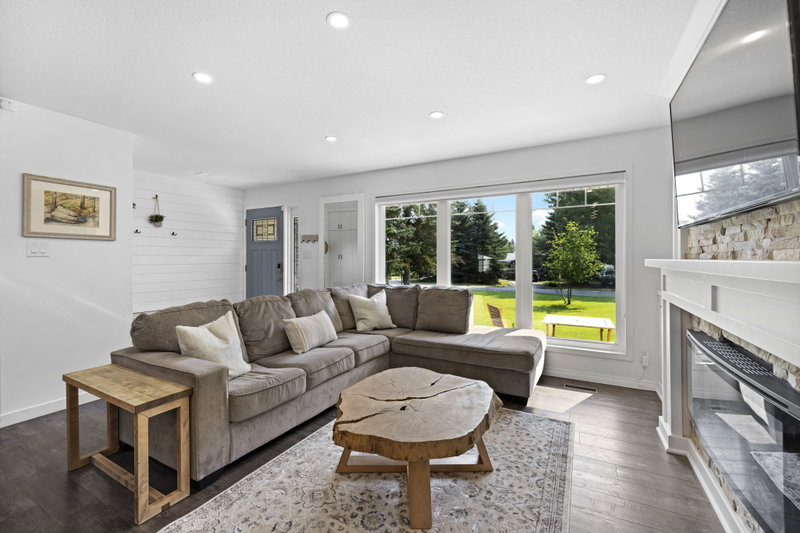 Living room with a sectional sofa and stone fireplace