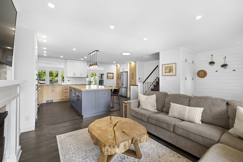 Open-concept living room and kitchen with a live-edge coffee table