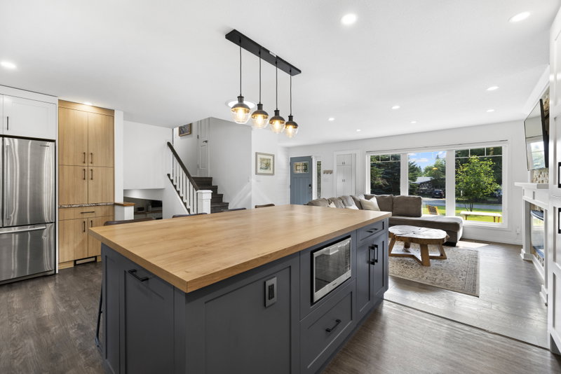 Kitchen island open to the entry, staircase and living room