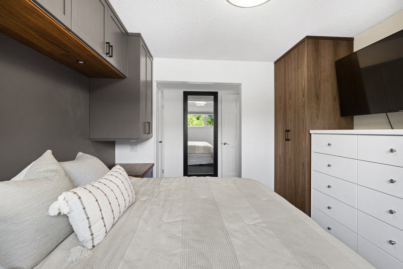 Primary bedroom with a built-in dresser and walk-through to the ensuite