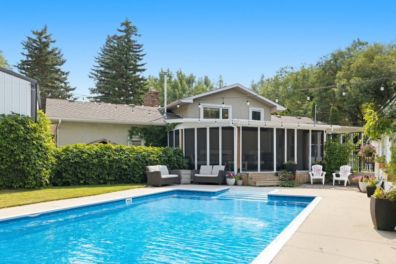 Two-storey home viewed across the pool