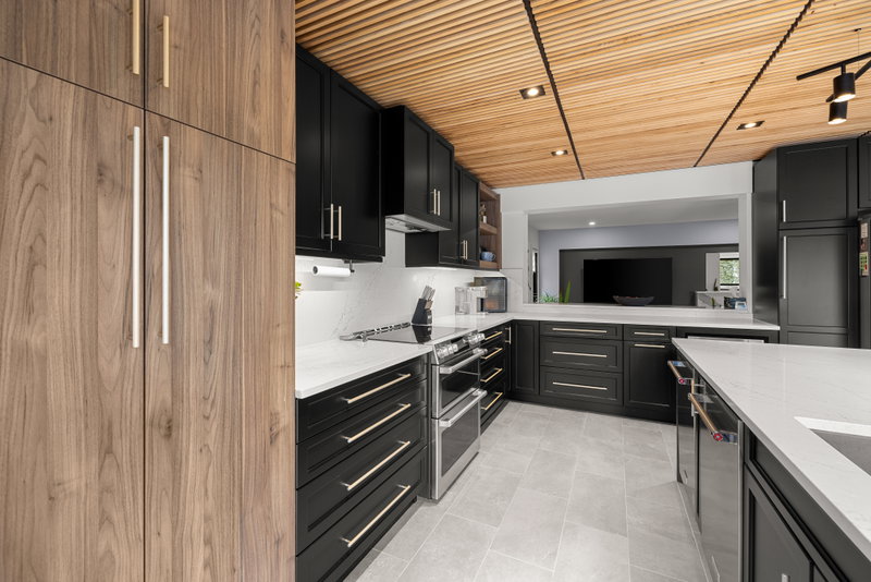 Kitchen with matte black cabinetry and a wood slat ceiling
