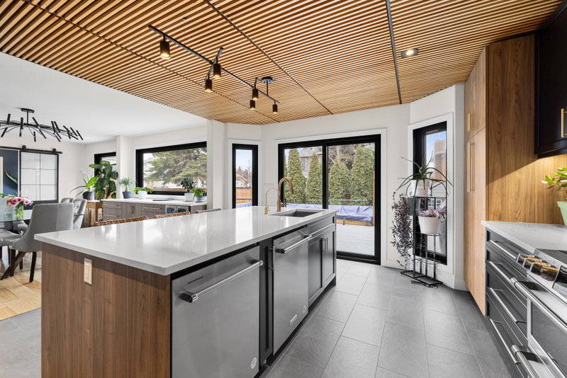 Range wall with matte black cabinetry and marble-look backsplash