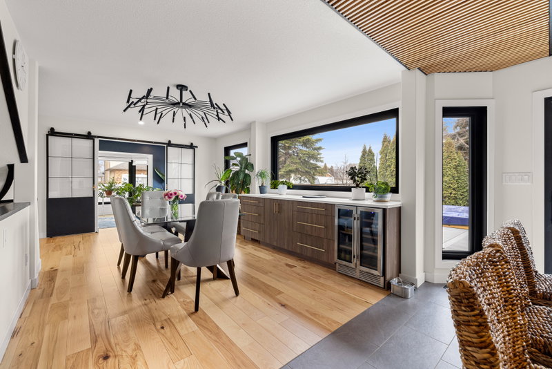 Dining area with a built-in sideboard, wine fridge and picture window