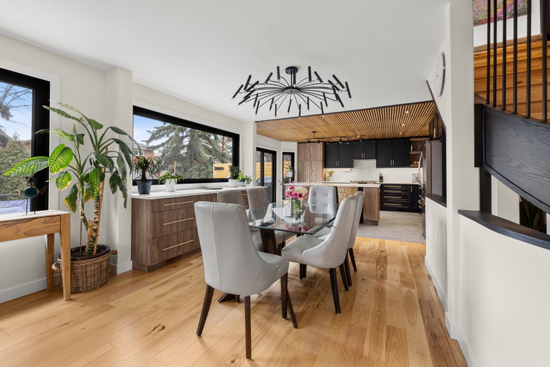 Dining table open to the kitchen, with staircase beyond
