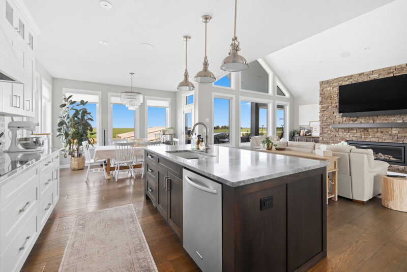 Kitchen island with stainless dishwasher, open to the living room fireplace