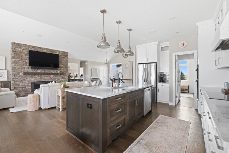 Kitchen island open to the living room fireplace and front entry