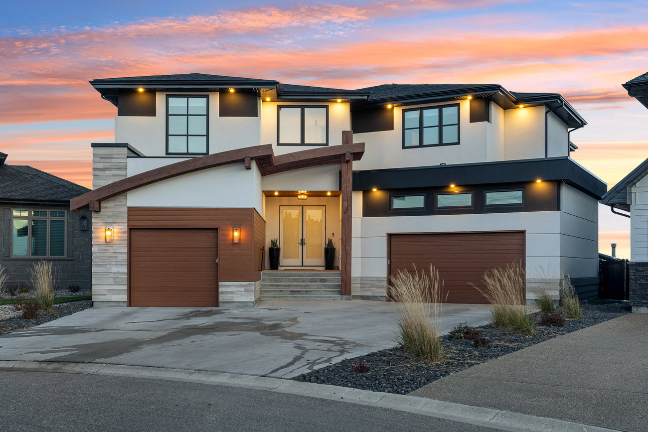Home exterior photographed at sunset with warm entry lighting