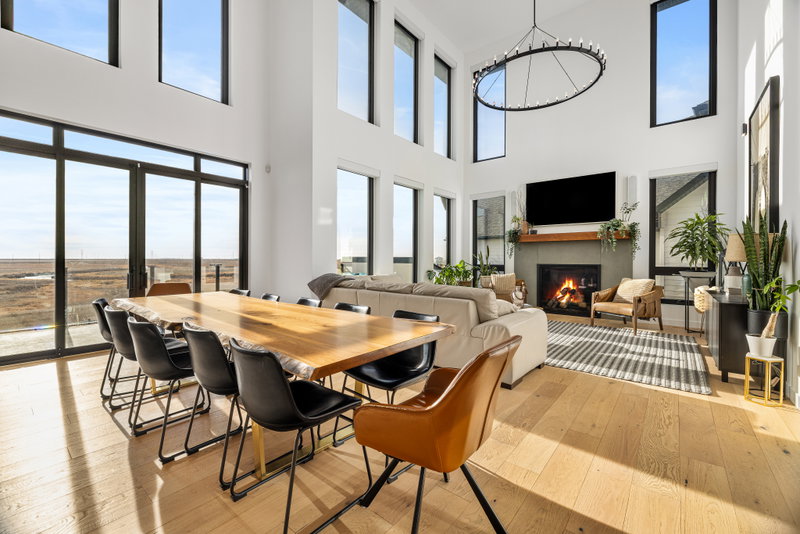 Dining area with a modern chandelier beside the kitchen