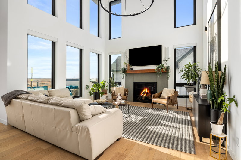 Living room with a fireplace and large front windows