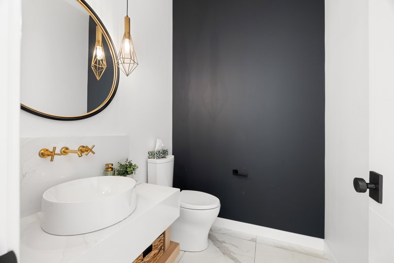 Bathroom with a tiled tub surround and modern vanity